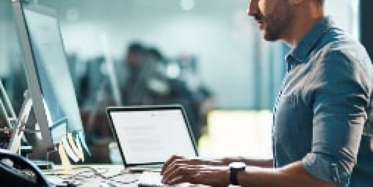 Man uses keyboard on desk